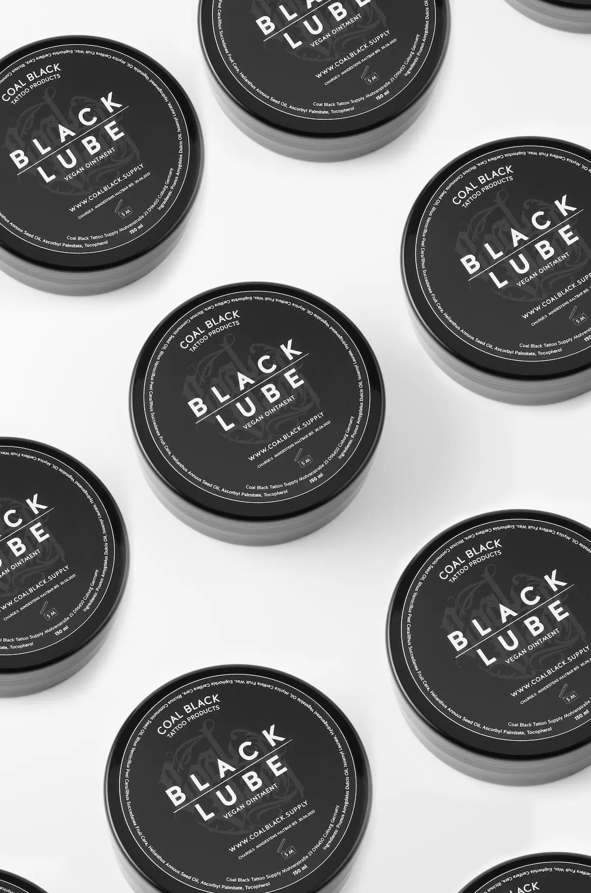 Coal black black lube in sleek black cylindrical containers with bold white branding for smooth lubrication