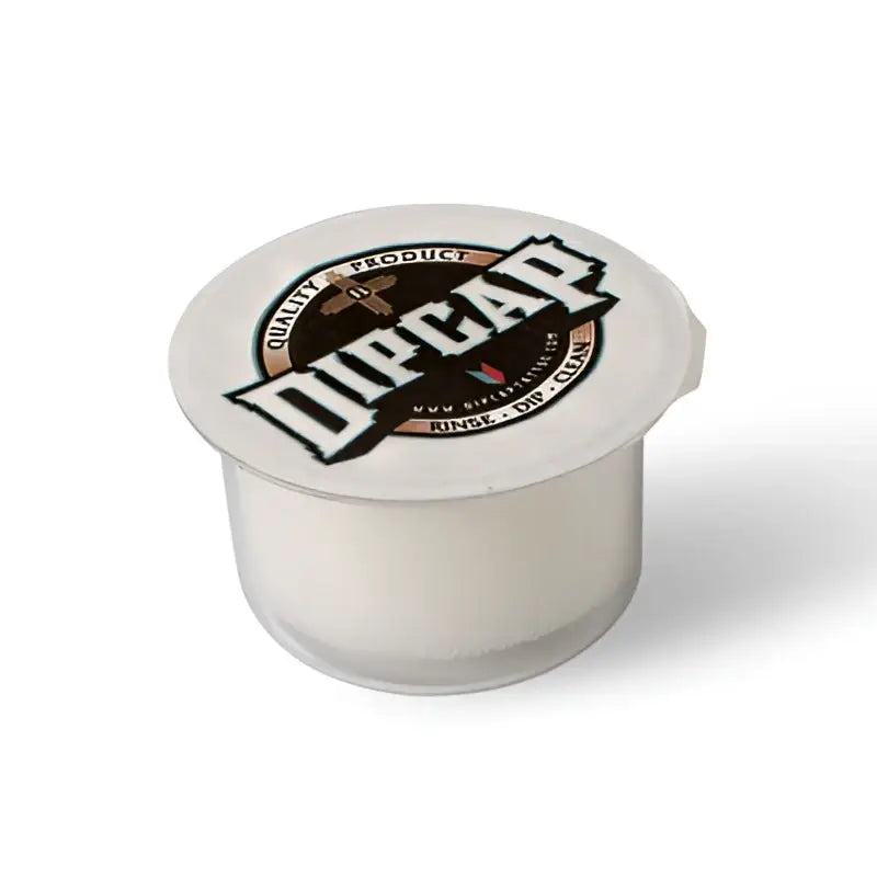 Duracap-Kaffeekapsel mit weißem Kunststoffkörper und kreisförmigem Deckel mit Duracap-Logo in Schwarz, Braun und Gold für die Verwendung mit Dipcaps zum Ausspülen