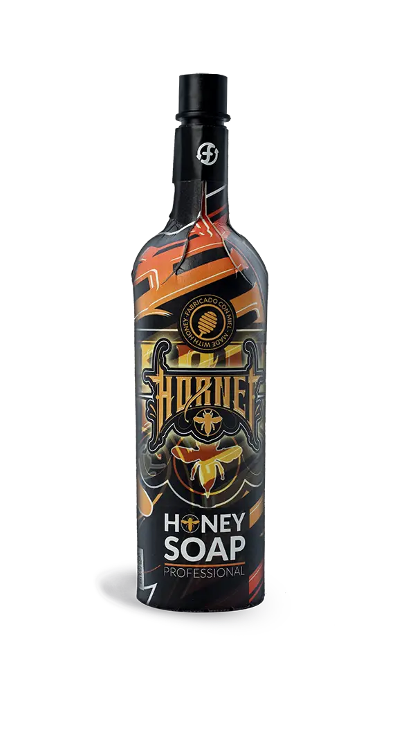 A sleek black 750 ml bottle of hornet honey soap with bold orange and gold bee-themed graphics on the label