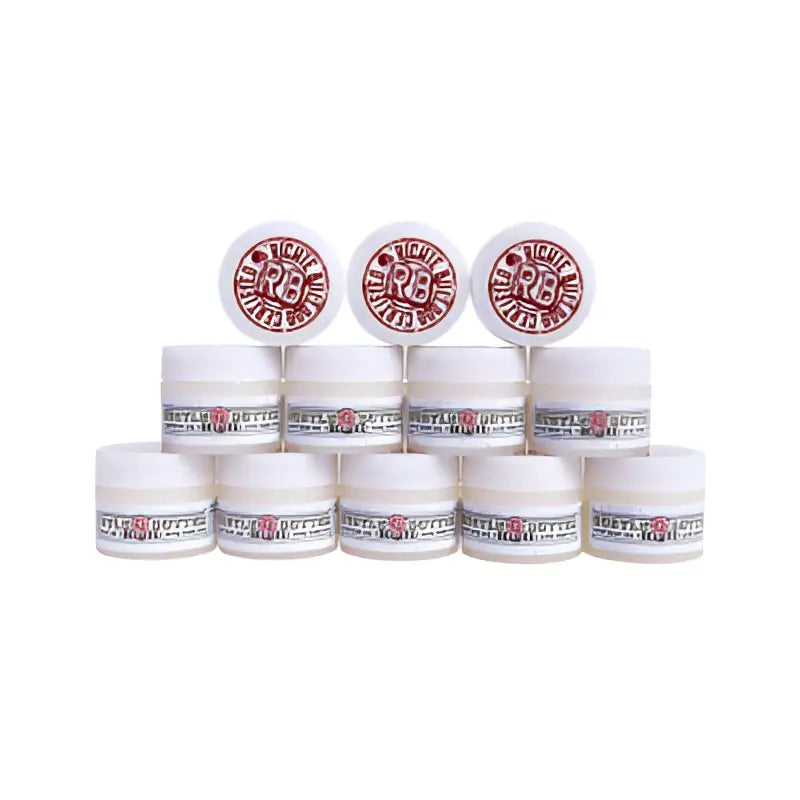 White cylindrical jars with red and black r3 logo labels arranged in a pyramid for hustle butter deluxe organic tattoo care