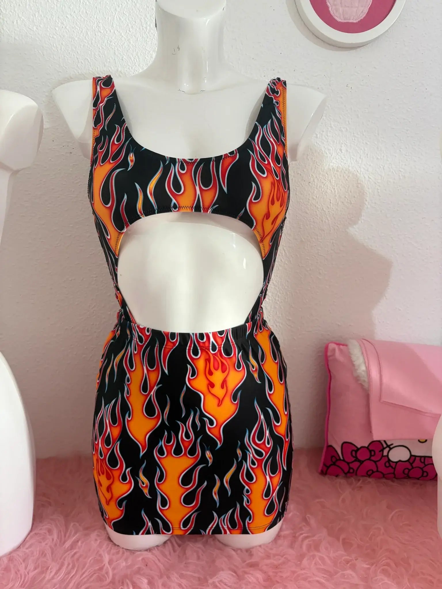 A vibrant orange and black flame patterned one piece swimsuit with midriff cutout from kalu ibiza vice attitude collection