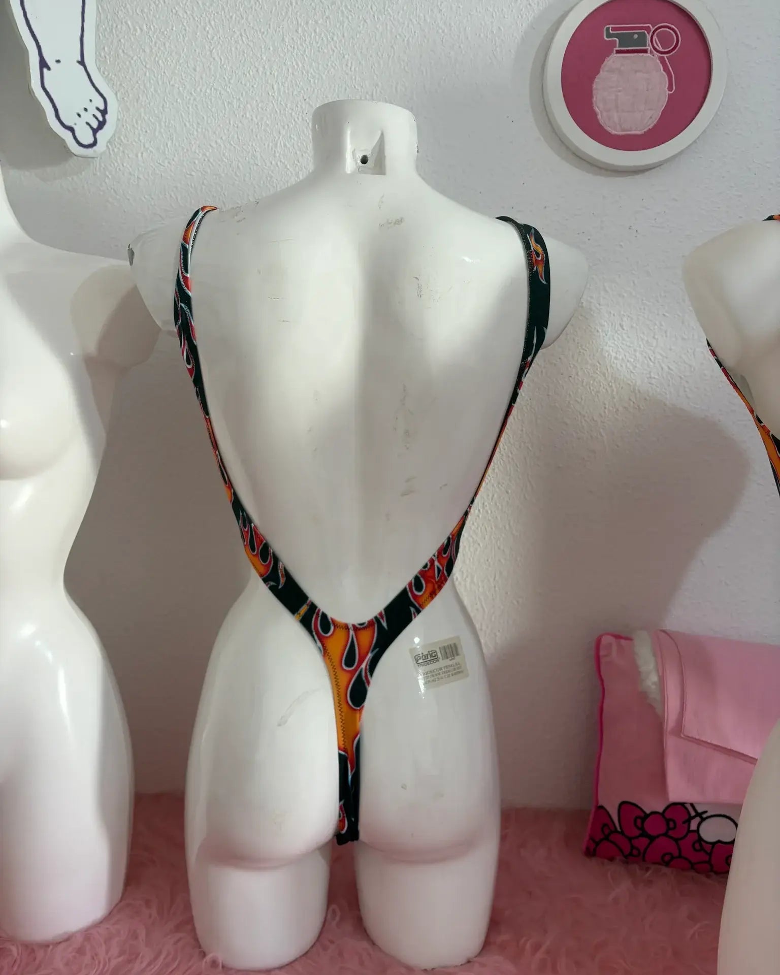 A vibrant orange and black patterned trikini teeth one-piece swimsuit with thin straps by kalu ibiza vice attitude