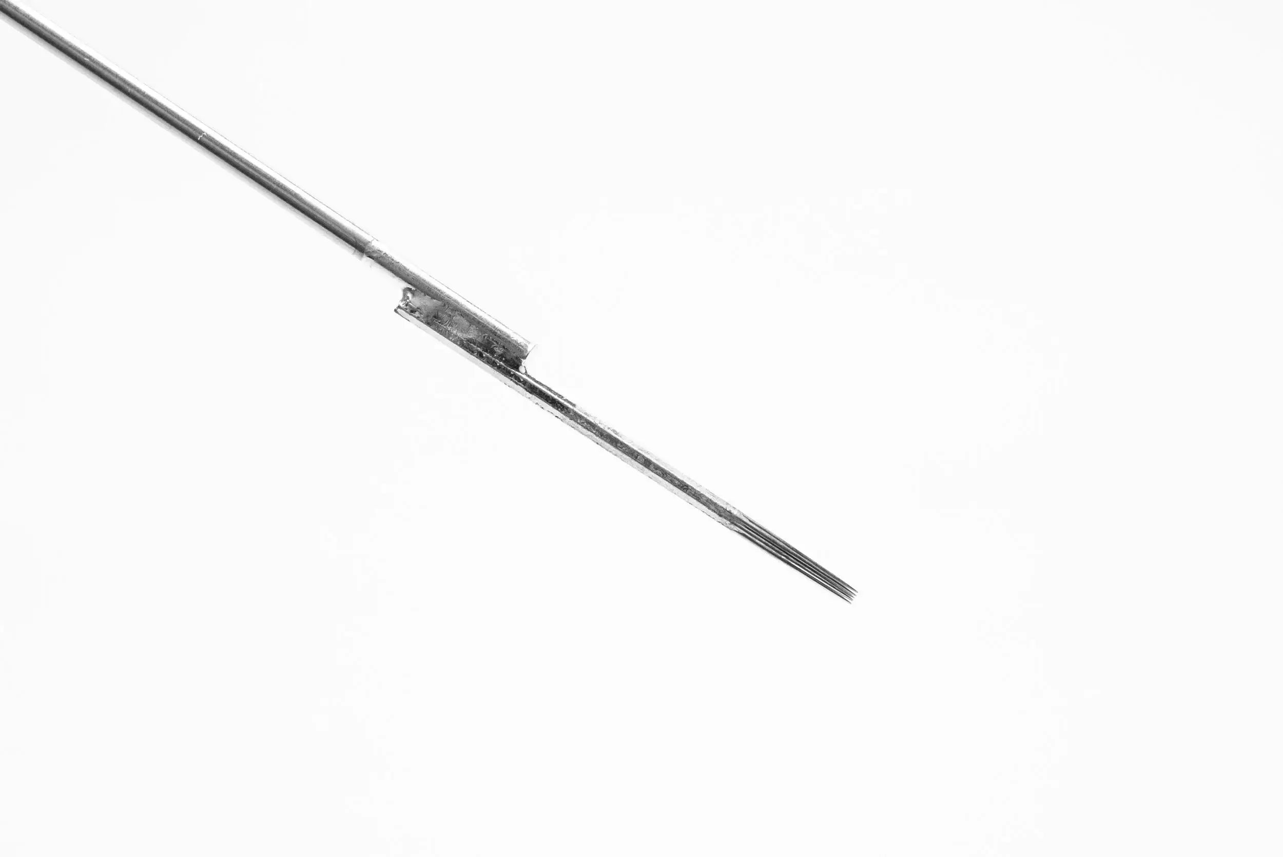 A sleek metallic lotus bar needle with a fine point and small rectangular component near the handle for precision lining
