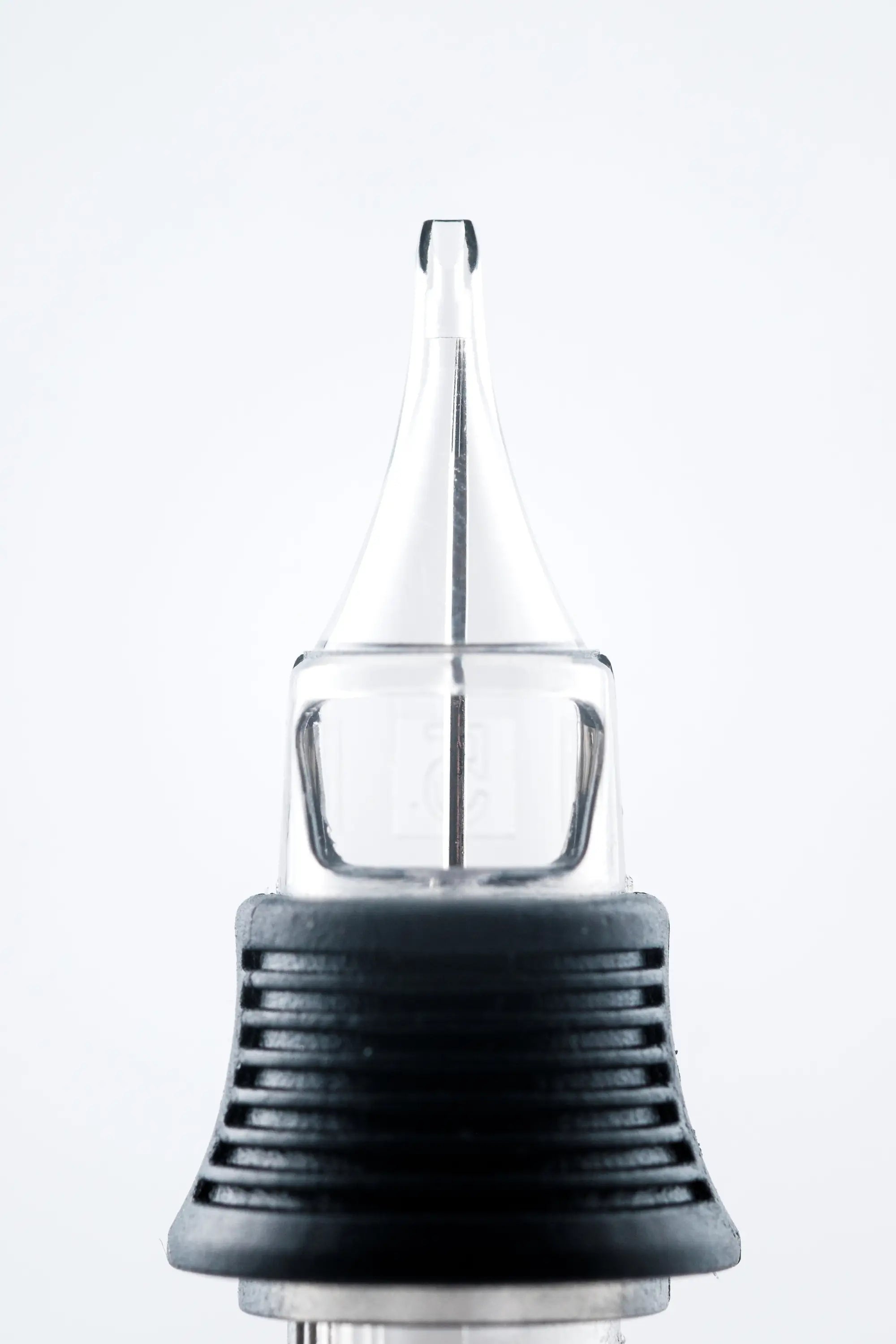 Nexus round liner cartridge with clear glass needle tip black textured grip and metallic base for precise tattooing