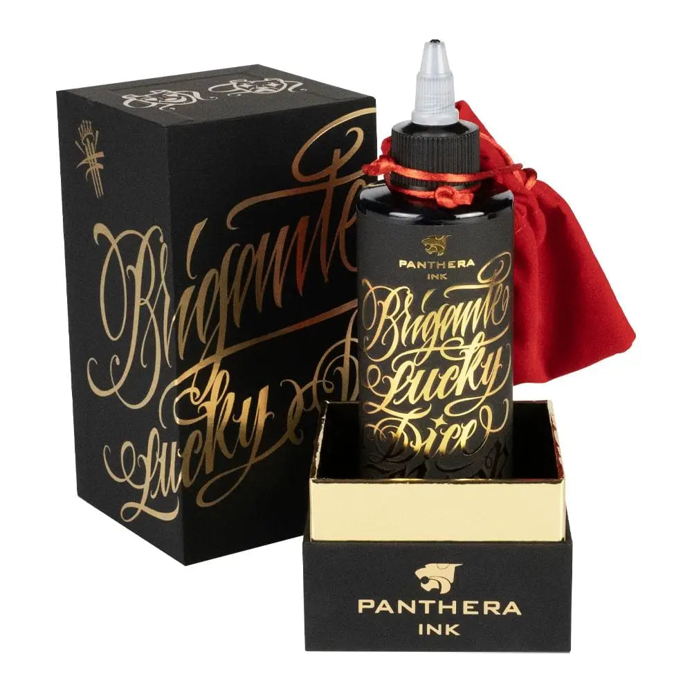 Black glass bottle of panthera ink with gold script labeling and red drawstring pouch for brigante lucky dice 200ml
