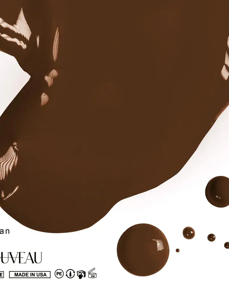 A rich glossy chocolate brown pmu pigment paint splatter with smooth viscous texture and subtle white feather patterns