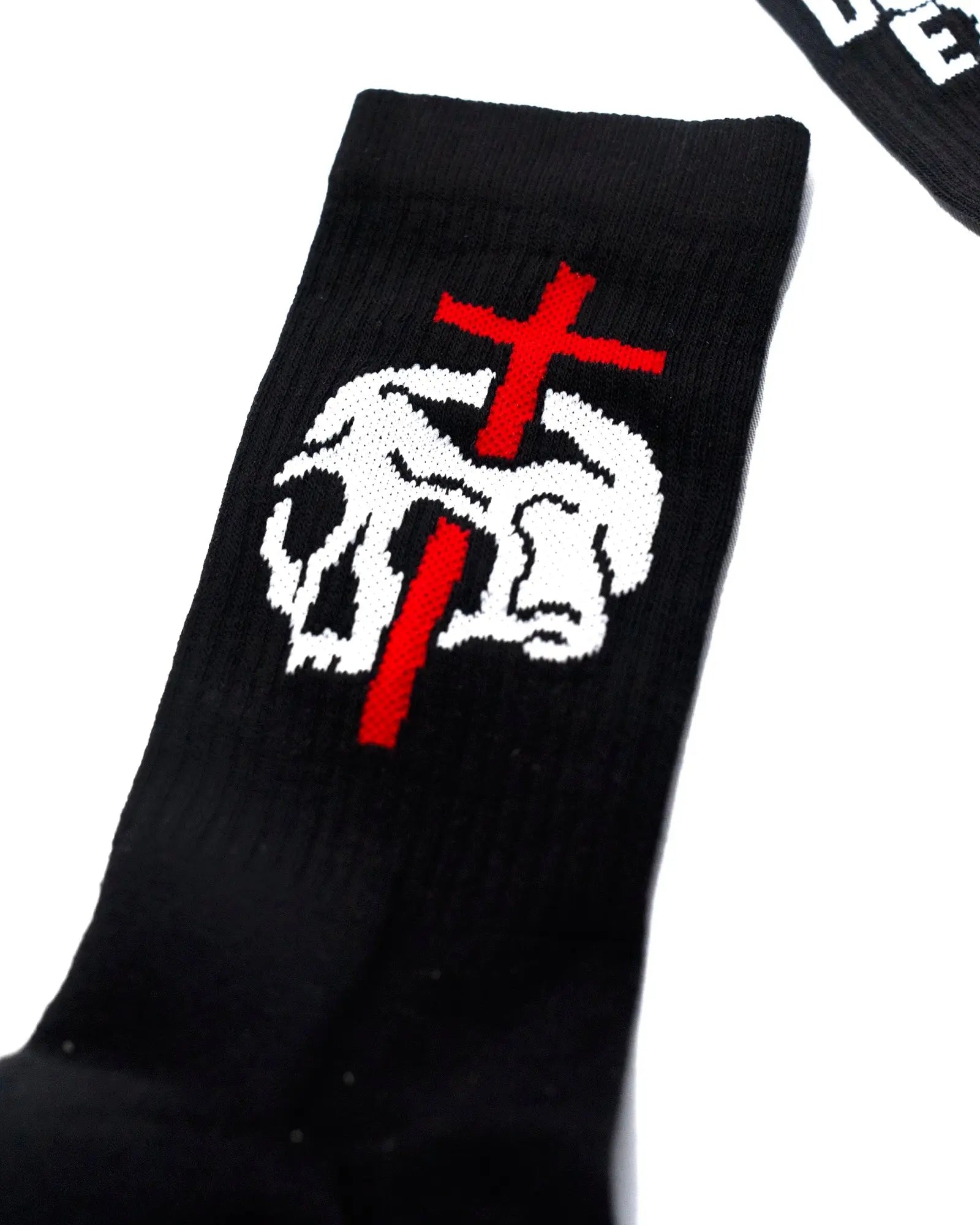 Black knit vice attitude socks featuring a white skull with a red cross stitched on the front no religion design
