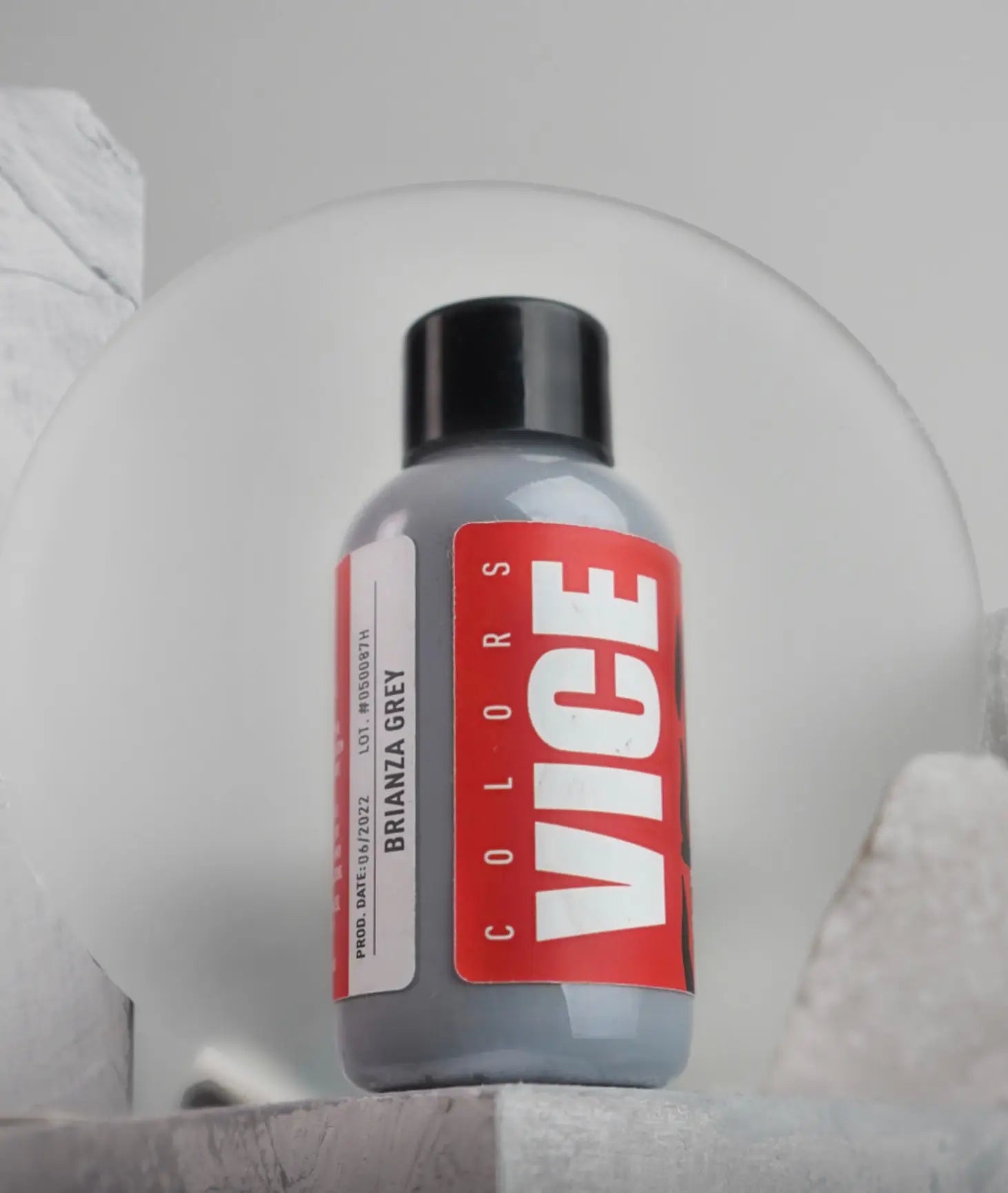 A sleek gray bottle of vice colors brianza grey paint with black cap and bold red label in vice brianza grey product