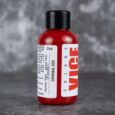 A vibrant red glossy plastic bottle with a black cap and bold vice colors label for vice criminal red product