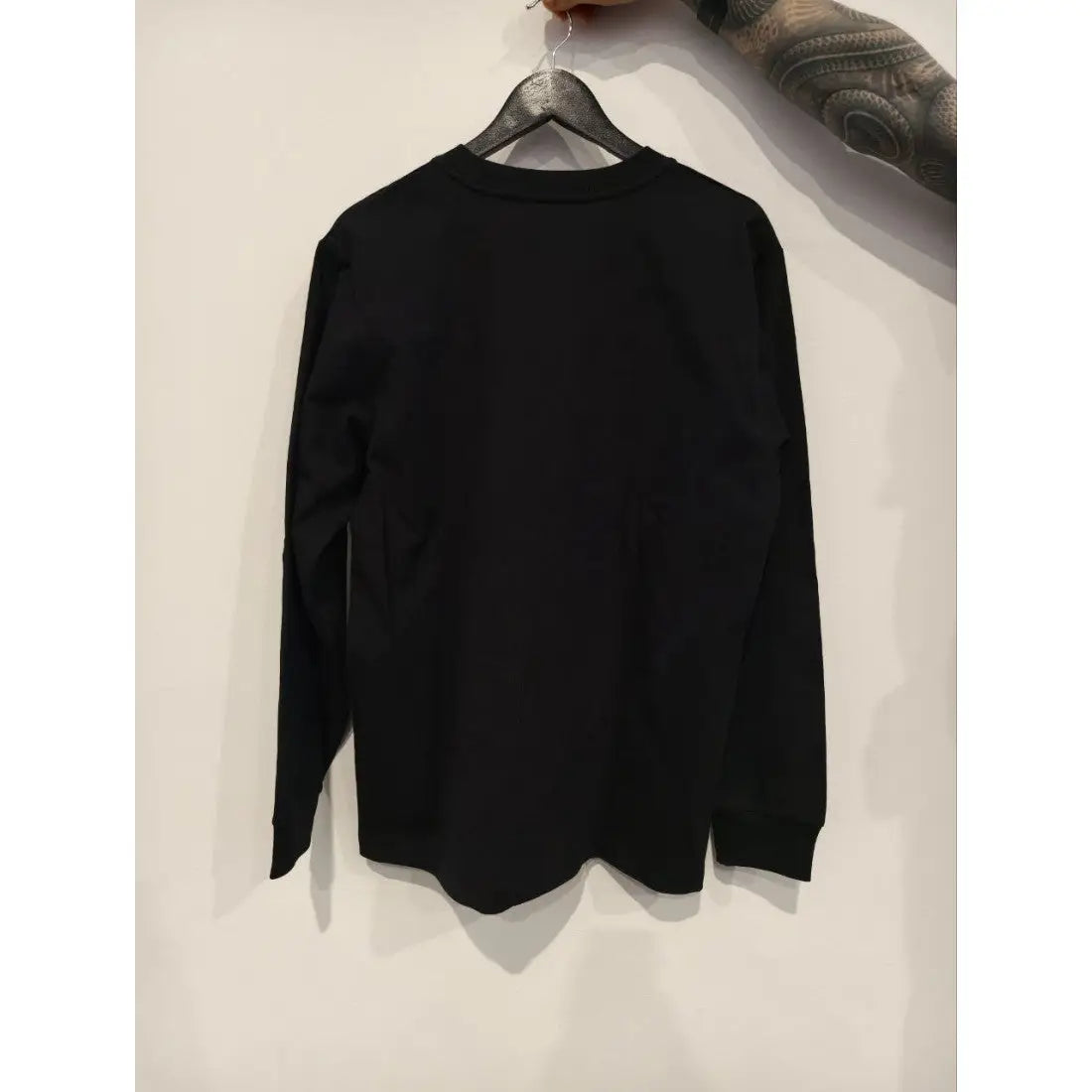 Vlad blad longsleeve vbi black black long-sleeved crewneck shirt hanging on a wooden hanger front view
