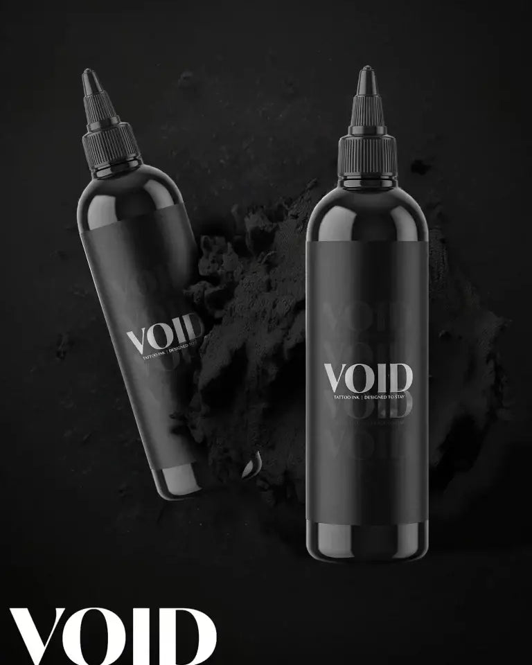 Two sleek black plastic bottles of void tattoo ink with minimalist white branding and black screw-top caps for black tattoo ink pigment structure