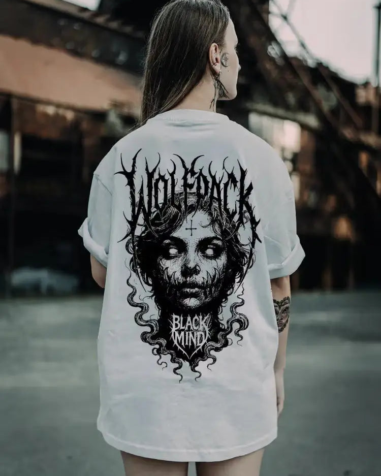 White oversized tee featuring a black ritual skull graphic with flowing hair and wolfpack black ritual text for unisex wear
