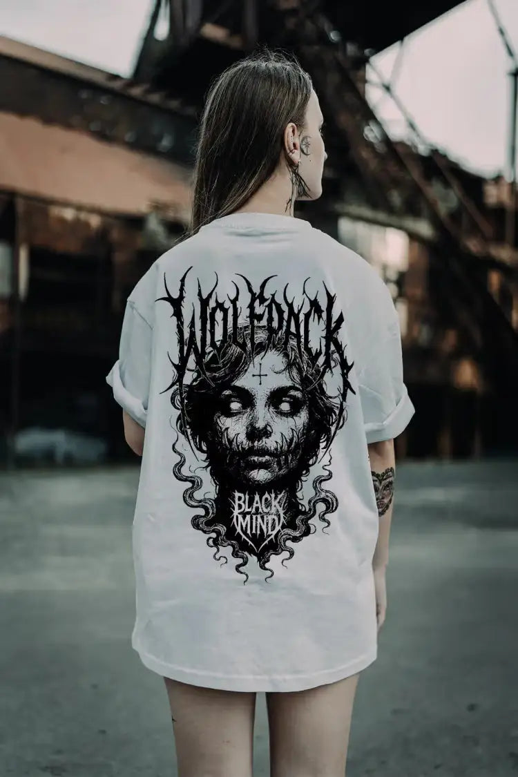 White oversized tee featuring a black ritual skull graphic with flowing hair and wolfpack black ritual text for unisex wear