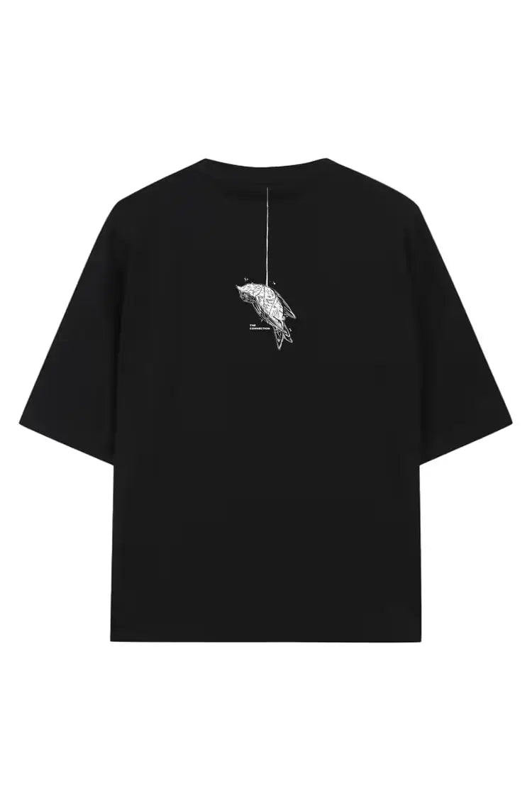 Back of black oversized tee unisex with white bird line-art hanging from string wears size shown