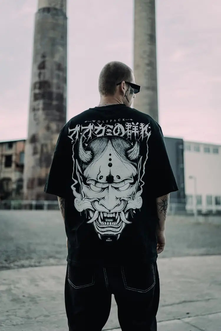 Black oversized tee unisex with large white oni mask graphic and japanese text on the back wears size shown
