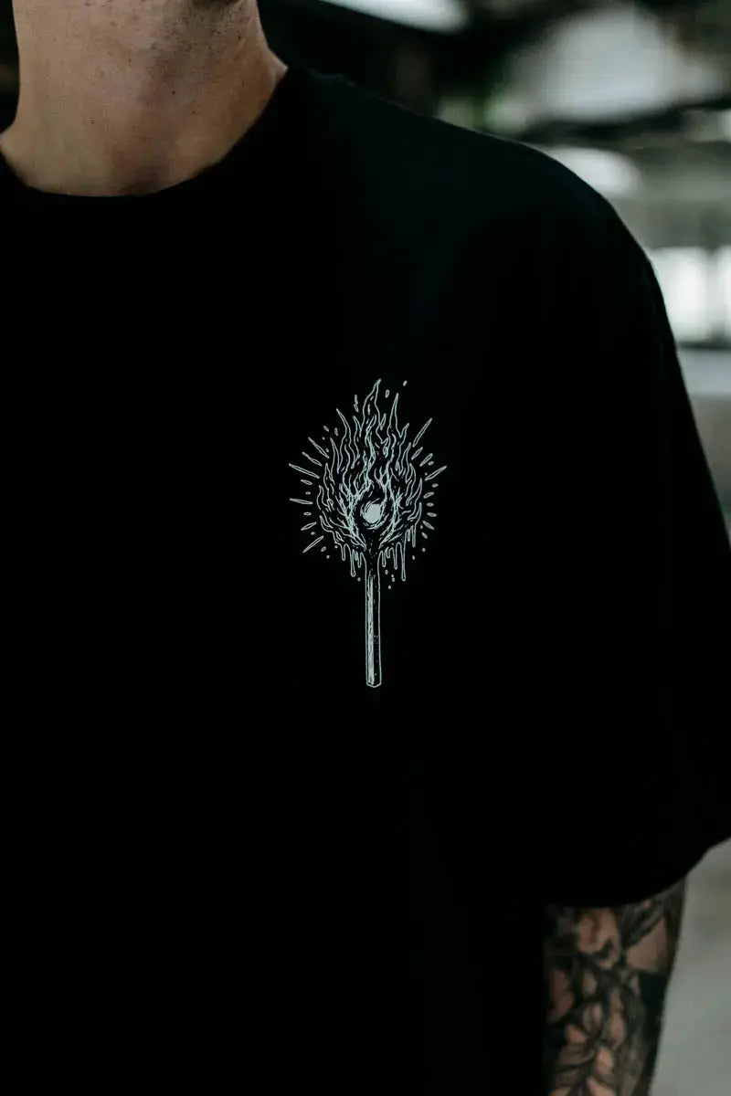 Black cotton oversized unisex t shirt with white line art flame and dripping wax graphic from wolfpack hell within collection
