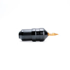 Black ACUS C2 tattoo machine with a gold-colored needle tip for precise and professional tattooing