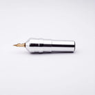 Silver metallic ACUS M1 Ayre tattoo machine with gold-colored needle tip designed for precise tattooing use