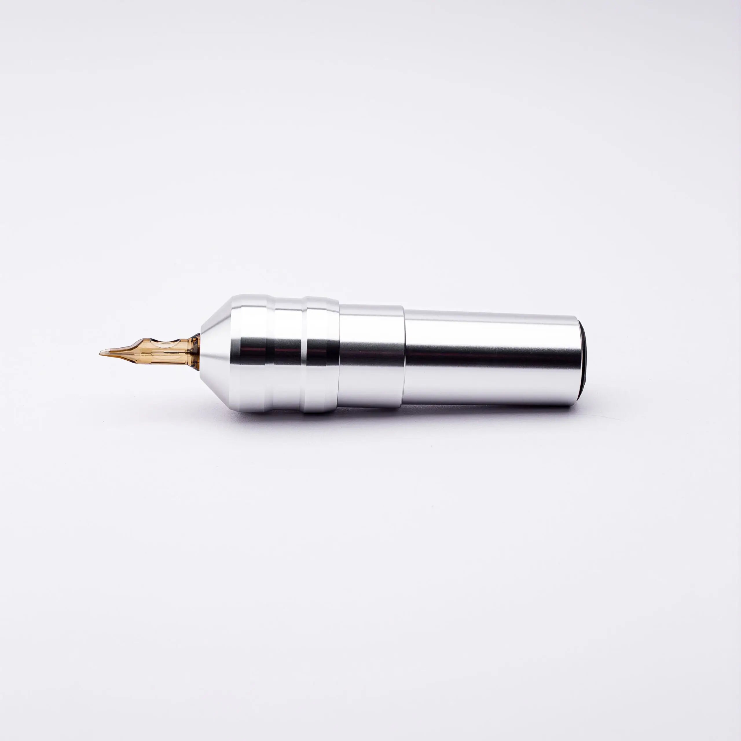 Silver metallic ACUS M1 Ayre tattoo machine with gold-colored needle tip designed for precise tattooing use