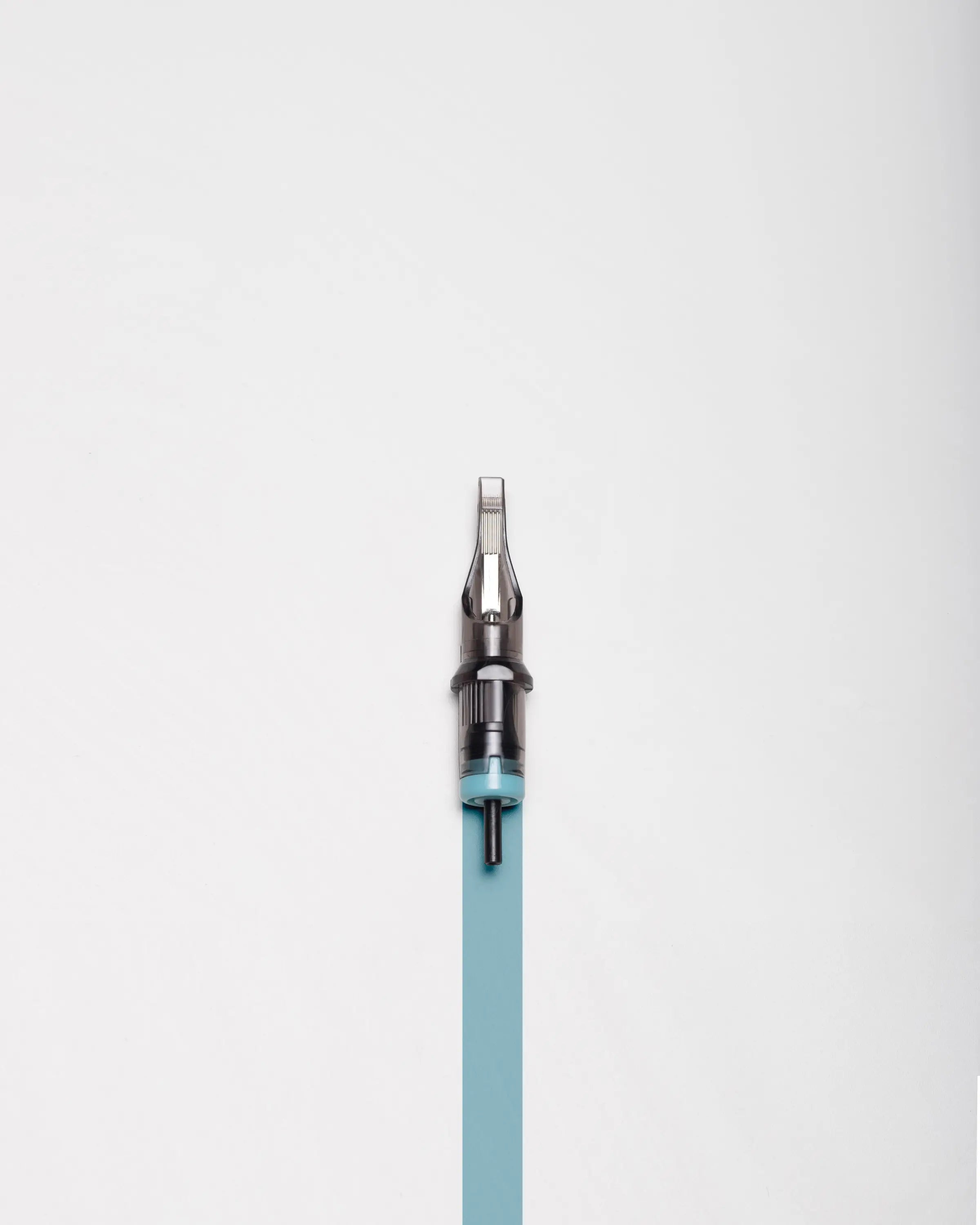 A sleek translucent teal blaze cartridges magnum tattoo needle with metallic tip and black grip for precision ink work