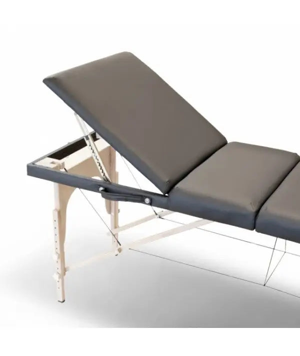 Adjustable massage table caos nero rental with dark gray padded surface and light wood tone legs for professional use