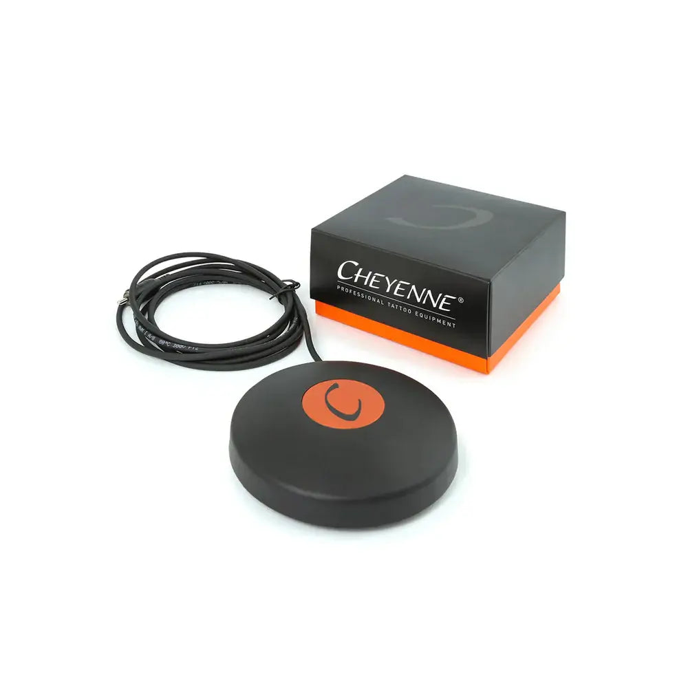 Black circular footswitch with orange power button by Cheyenne professional tattoo equipment for precise control