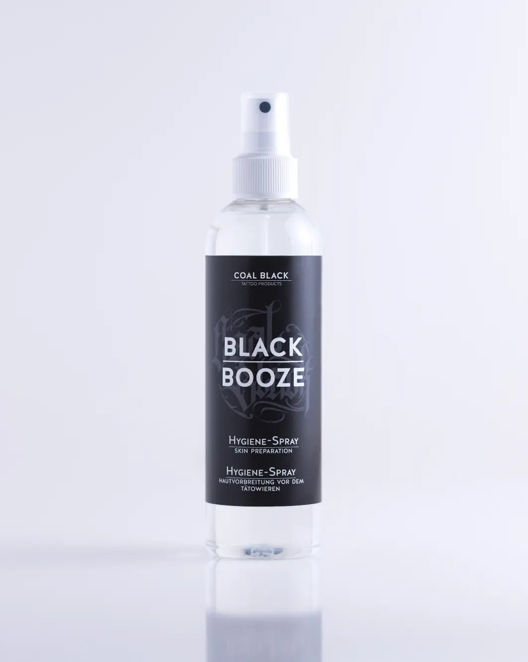 Clear plastic spray bottle with white nozzle labeled coal black black booze for coal black product use