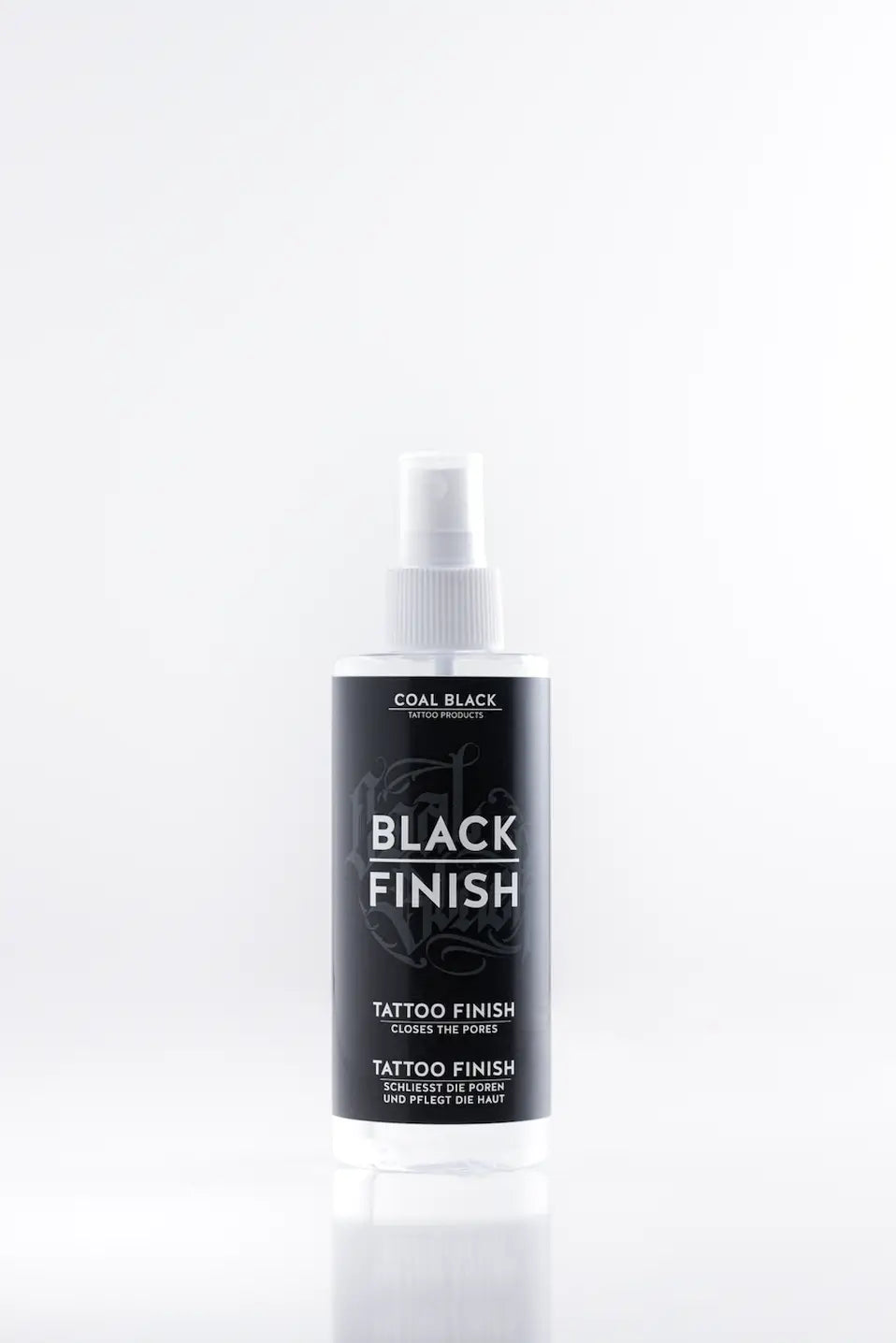 COAL BLACK schwarzes Tattoo-Finishing-Spray in einer eleganten transparenten Flasche mit weißer Düse und schwarzem Etikett