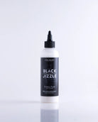 A sleek white bottle with black cap and label of coal black black jizzle long-lasting stencil fluid product