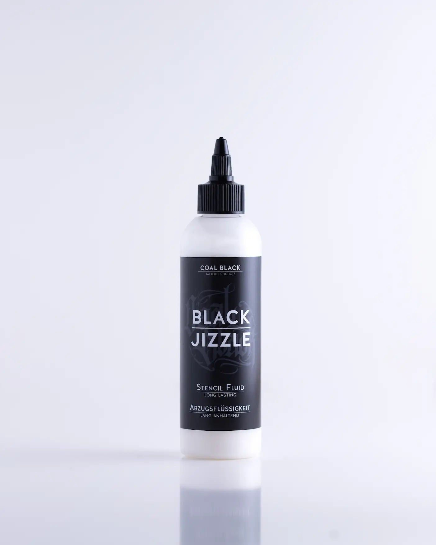 A sleek white bottle with black cap and label of coal black black jizzle long-lasting stencil fluid product