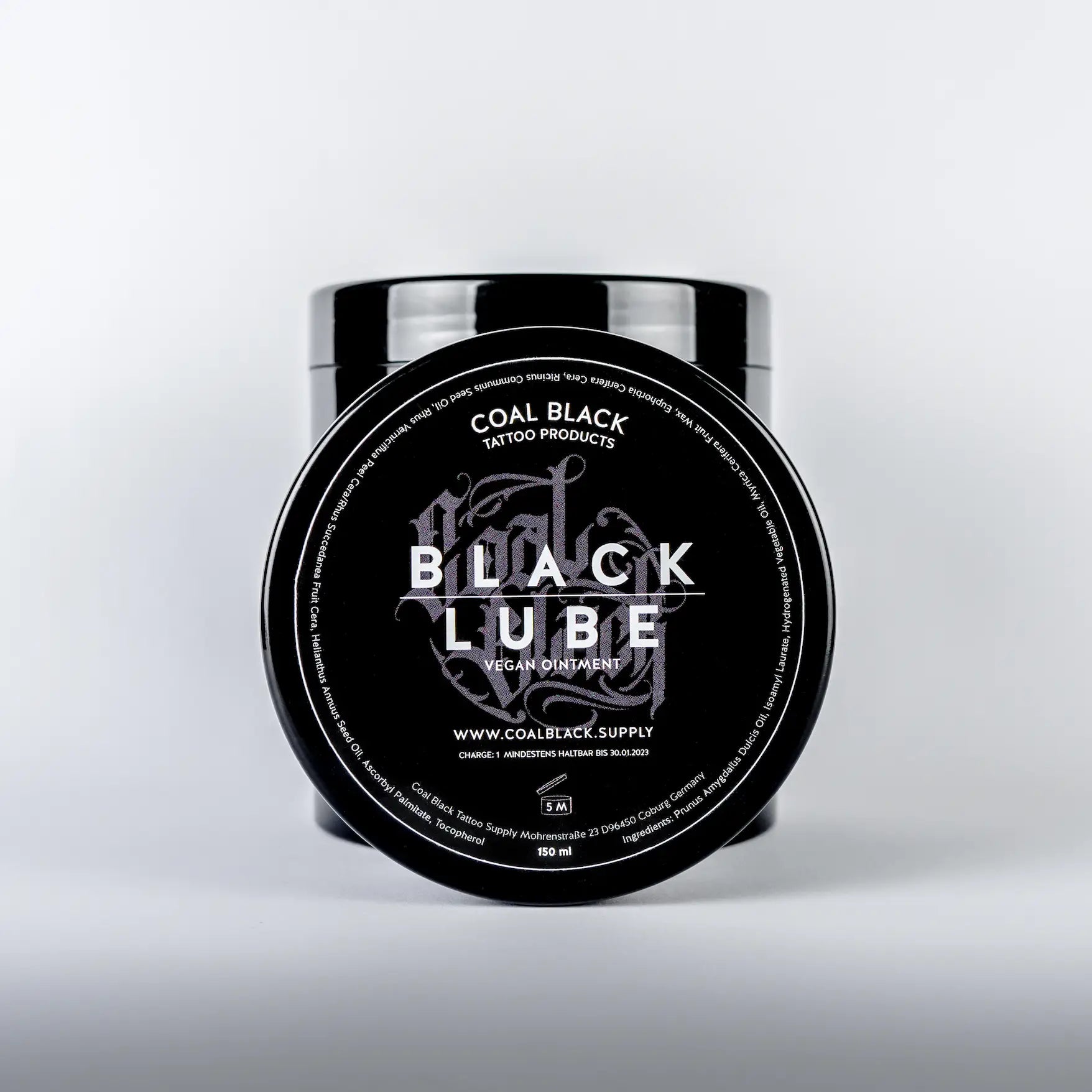 Black lube vegan ointment in a sleek black jar with silver lettering from coal black tattoo products