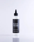 Clear plastic bottle with black cap and label featuring black water text for coal black black water product