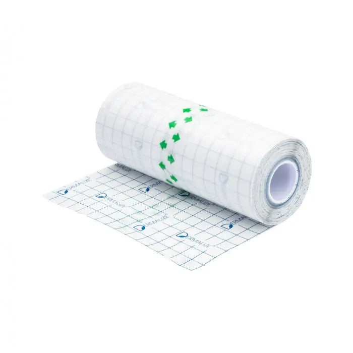 A roll of white grid-patterned adhesive protective tattoo film tape with green arrows and dermatix logo in blue