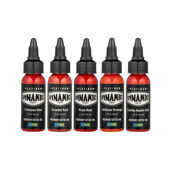Five bottles of dynamic platinum premium tattoo ink in red and orange shades with black caps and labels in envy set