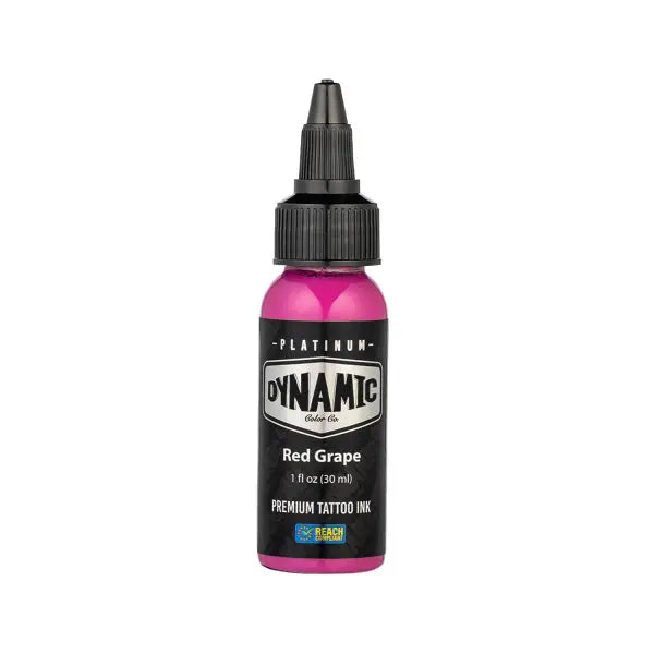 A vibrant pink bottle of dynamic platinum red grape tattoo ink with a black cap and label from the lush set