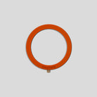 Orange circular MagSafe ring with a metallic tab on the bottom for the GOAT G8 upgrade kit accessory