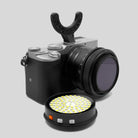 Black and silver GOAT light support camera with black lens and black u-shaped grip mount for stable shooting