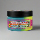 Ein farbenfrohes Glas mit Farbverlauf von good hand Double Butter 250ml mit schwarzem Deckel und buntem Cartoon-Etikett