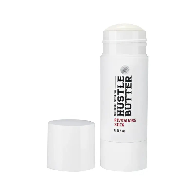 White cylindrical hustle butter deluxe revitalizing stick with white cap and black red label for skin care 45 g