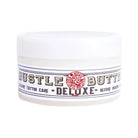 White plastic jar of hustle butter deluxe luxury organic tattoo care for moisturizing and healing tattooed skin
