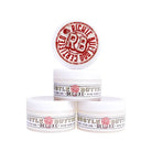 White cylindrical tubs of hustle butter deluxe organic tattoo care with red and black branding stacked in pyramid formation