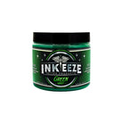 Ink-eeze grüne Glide-Tattoo-Salbe in zylindrischem Glas mit schwarzem Deckel und metallisch silbernem Etikett zur Tattoo-Pflege