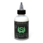 A clear plastic bottle with a black cap and nozzle labeled stencil stuff by INTENZE for stencil application