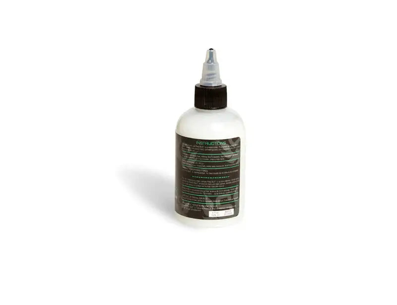 White plastic bottle with black cap and clear nozzle labeled instructional in green for intenz stencil stuff product
