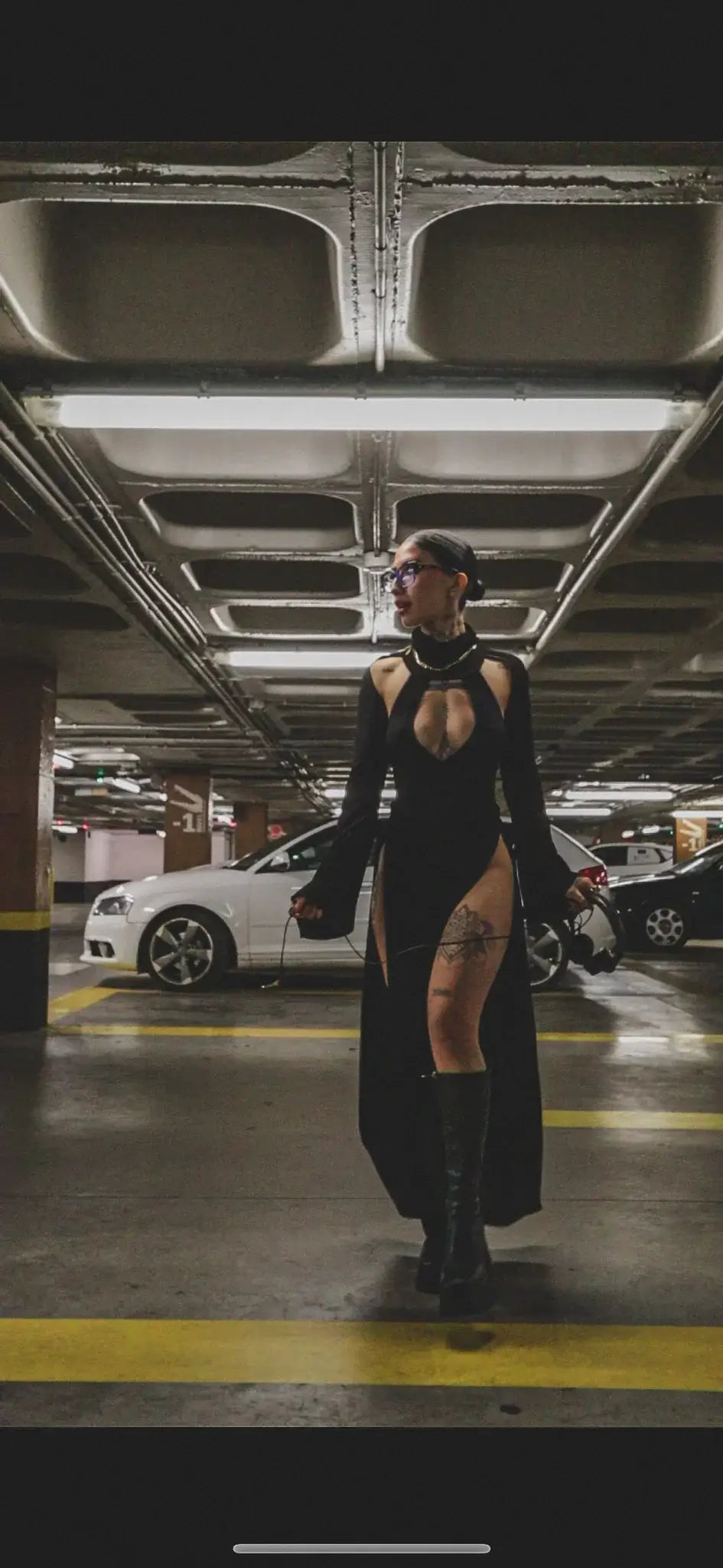 Black high-necked long-sleeved kalu ibiza dj dress with cutouts and thigh-high slit by bikini goat