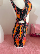 Kalu ibiza flames mini skirt with black and orange flame pattern halter neck and cutout details for vice attitude style