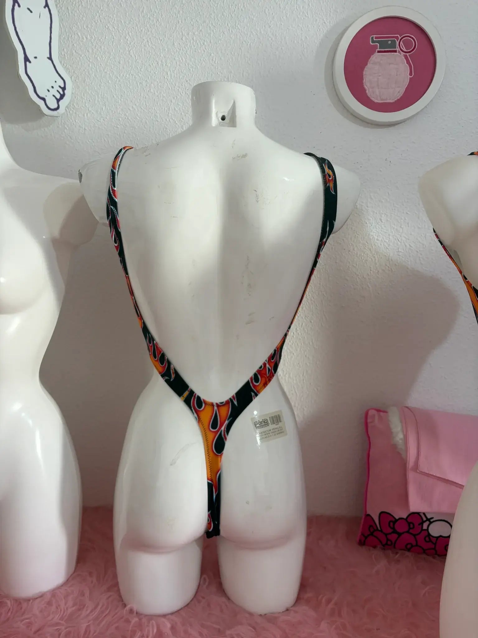 A vibrant orange and black patterned trikini teeth one-piece swimsuit with thin straps by kalu ibiza vice attitude