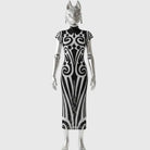 Silver figure in black dress with white tribal ornaments