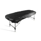 Black textured fabric elasticated bed cover draped over foldable massage table for killer ink black line set