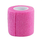 A roll of killer ink grip wrap pink 50mm x 4.5m bright pink textured elastic wrap with a white inner core